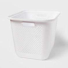 a white plastic laundry basket on a white background