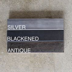 four different types of signs on the side of a building that says silver, blackned, antique