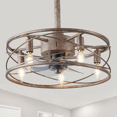 a light fixture with four lights hanging from the ceiling