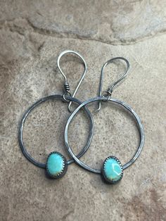 "Gorgeous paired Kingman Turquoise is held within serrated sterling silver bezels. These sit in the center of hand forged sterling silver hoops with a stunning texture. These hoops hang from hand twisted, hammered sterling silver ear wires. I have oxidized and brought these to a rustic finish to compliment the design. Lightweight on the ears given their size. Ready to ship! Xo  MATERIALS: Sterling silver, sterling silver wire, sterling silver threaders and paired Kingman Turquoise cabochons  MEA Handmade Turquoise Sterling Silver Hoop Earrings, Artisan Small Hoop Sterling Silver Jewelry, Turquoise Sterling Silver Hoop Earrings, Artisan Hammered Hoop Jewelry, Hammered Turquoise Sterling Silver Jewelry, Turquoise Soldered Sterling Silver Earrings, Handmade Turquoise Hoop Jewelry, Sterling Silver Turquoise Hoop Earrings, Turquoise Hammered Sterling Silver Jewelry