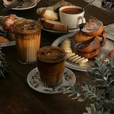 a table topped with plates of food and cups of coffee on top of each other