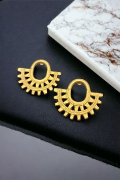 Finish your look with these stunning mini crescent earrings. They are a true standout.  Our Precolumbian pieces are inspired by the beautiful gold-work made by ancient indigenous civilizations that once lived in Colombia before the arrival of the Spaniards  in  1.492. Our Precolumbian pendants are replicas made of 24k gold plated, nickel free pewter, and will be embellished by semiprecious stones, ceramic beads, and natural materials. Gold Semi-circle Earrings For Gift, Gold Semi-circle Metal Earrings, Gold Crescent Cartilage Earrings, Semi-circle Brass Earrings For Gifts, Gold Crescent Cartilage Earrings Nickel Free, Unique Crescent Gold Earrings, Gold Plated Crescent Earrings, Crescent Earrings, Jewelry Statement