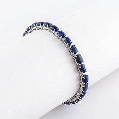 Experience the allure of elegance with our **Blue Sapphire Tennis Bracelet**. Handcrafted with love and precision, this exquisite piece of jewelry is more than just an accessory. It's a statement of sophistication, a testament to timeless fashion. Made with **925 fine silver this bracelet is the perfect anniversary gift that will make her feel truly special. ## Key Features - **Stunning Blue Sapphire Each bracelet features a series of carefully selected blue sapphires, known for their vibrant co Sterling Silver Gemstone Tennis Bracelet, Silver Sapphire Bangle Bracelet, Hand-set Sapphire Bracelet As Gift, Classic Sapphire Bracelets For Anniversary, Sapphire Bracelets With Prong Setting For Anniversary, Elegant Sapphire Sterling Silver Bracelet As Gift, Elegant Sapphire Bracelets As Gift, Elegant Sapphire Bracelets Perfect For Gifts, Sapphire Jubilee Bracelet For Wedding