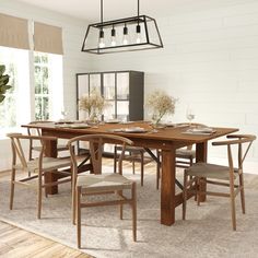 a dining room table and chairs in front of a large window with white brick walls