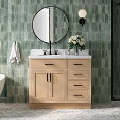 a bathroom with a sink, mirror and bathtub next to a shower stall in front of a green tiled wall