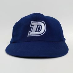 "Here is an authentic Chunichi Dragons game issued cap from the 1980s. This cap features the team's Dragons \"D\" logo on the front. The six-point crown suspension's interior is lined with a white cloth sweatband. A size 59cm-60cm tag is sewn inside the cap. This would be equivalent to a U.S. size 7 3/8. This hat is a truly unique piece. History The Chunichi Dragons are a professional Japanese baseball team in the NPB's Central League. With their home ground at Nagoya Dome, they are the Tokai re Retro Fitted Cap For Fan Gear, Retro Fitted Hat With Curved Brim For Sports Events, Retro Flat Bill Hat With Embroidered Logo, Retro Fitted Hat With Flat Brim For Sports Events, Retro Curved Brim Fitted Hat For Sports Events, Retro Flat Brim Snapback Hat For Baseball Season, Retro Trucker Hat For Baseball Season, Retro Baseball Season Hat With Embroidered Logo, Retro Hat With Embroidered Logo For Baseball Season