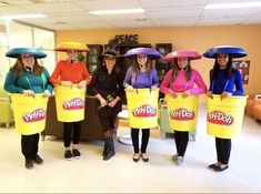 five women wearing buckets with hats on their heads