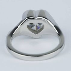 a white gold ring with a heart shaped diamond