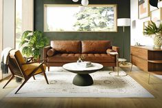 a living room filled with lots of furniture next to a wall mounted painting on the wall