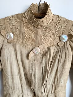 The most glorious antique ecru silk blouse. High neck, puff shoulder, lace at cuffs and chest, delicate pin tucks at front and back. So many good details and such structure. Fabric: Silk & laceFit: XS Measurements: Bust 30” Shoulders 12.5” Sleeve 20”Waist 24” Arm opening (flat) 7” Neck 12.5” Condition: Good. As found antique. Historical Victorian Dress With Buttons, Elegant Victorian Dress For Vintage Fashion, Elegant Victorian Dress With Buttons For Daywear, Elegant Long Sleeve Victorian Dress With Buttons, Elegant Cream Victorian Dress For Daywear, Elegant Victorian Dress For Daywear, Elegant Victorian Dress With Historical Design, Elegant Victorian Dress With Historical Design For Daywear, Elegant Victorian Dress With Buttons