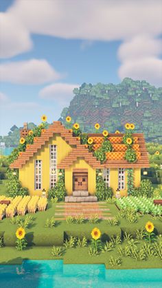 a yellow house with sunflowers on the roof and water in front of it