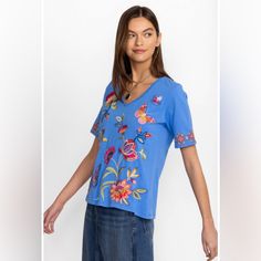 Nwt Johnny Was Gracey Trapunto Vneck Tshirt Small Crafted From 100% Breathable Cotton, The Gracey Trapunto V-Neck T-Shirt Is A Fresh Twist On A Closet Staple. Featuring A V-Neckline, And Colorful Placement Embroidery, This Tee Offers Short Sleeves And A Relaxed Fit For Everyday Comfort. Pair With Linen Shorts And Leather Sandals For A Weekend Of Vacation Sightseeing. 100% Cotton Model Height: 5'11 1/2" Model Is Wearing A Size Small Measurements For Size Medium: Bust - 42", Length - 26 1/2" Care Instructions: Machine Wash Cold Only. Non-Chlorine Bleach When Needed. Tumble Dry Low. Warm Iron. Sku: J13224-2:Ulm:Xl Y08 Casual Blue Short Sleeve V-neck Top, Blue V-neck T-shirt For Spring, Casual Blue V-neck T-shirt, Blue Cotton V-neck T-shirt, Placement Embroidery, Linen Shorts, Johnny Was, Model Height, Leather Sandals