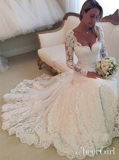 a woman sitting on a couch wearing a wedding dress and holding a bouquet in her hand