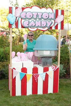 a woman standing in front of an ice cream cart