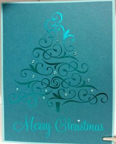 a blue christmas card with a tree on it