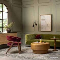 a living room filled with furniture and green walls