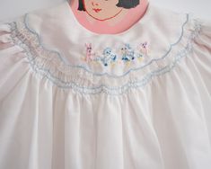 A precious vintage baby girl dress in crisp white with the sweetest embroidery detail on the collar. This white dress featured blue stitching detail, a collar and a precious embroidery of animals. It's approximately size 3-6 months Vintage approximately 3-6 months Measurements: Pit to Pit 11 Inches, Shoulder to hem: 11.5 inches 65% Polyester, 35% Cotton As with all vintage, we inspect each piece to determine any issues but we can not guarantee we didn't miss small imperfections.Why buy vintage? Dress With Embroidery, Vintage Baby Clothes, Vintage Baby Girl, Heirloom Sewing, Embroidery Details, Vintage Baby, Vintage Dress, Second Life