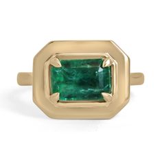 A stylish solitaire emerald ring that showcases an exquisite emerald-cut emerald set east to west. The gemstone displays the most beautiful rich forest green color with very good transparency and luster. Set in a four-prong claw setting, crafted in solid 14K gold.  Setting Style: Prong Setting Material: 14K Yellow Gold Setting Weight: 5.8 Grams Main Stone: Emerald Shape: Emerald Cut Weight: 2.30-Carats Clarity: Transparent Color: Rich Forest Green Luster: Excellent Treatments: Natural, Oiling Origin: Zambia Estimated Retail Value: $11,790.00 USD Keep in mind we custom create all of the items listed here. If you have a special request for a custom-created item please contact us at 1 800 840 6828. Complimentary shipping with the USA. Emerald Solitaire Ring, Emerald Band Ring, Emerald Set, Emerald Band, Gold Anniversary Rings, Emerald Cut Engagement, Forest Green Color, Alexandrite Engagement Ring, Bezel Set Ring