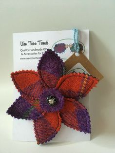 an orange and purple flower on a card