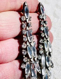 Featured is a gorgeous pair of antique paste extra long dangle earrings. Art Deco era 1920-1935. Possibly earlier. Earrings measure 2.75 inches long x .75 inches wide. Weighs 12.7 grams. These antique earrings test as paste stones and are silver filled with the remains of a gold wash on the backs. A new pair of sterling silver (marked 925) push backs have been added. All paste stones are clear and sparkly with no yellowing or greying at all! No missing paste stones. All paste stones are also fre Vintage Silver Sparkling Earrings, Vintage Sparkling Stone Drop Earrings, Vintage Jewelry With Sparkling Stones In Drop Earrings, Silver Costume Jewelry Earrings For Vintage Events, Silver Art Deco Chandelier Earrings For Evening, Vintage Crystal Drop Earrings, Vintage Silver Earrings With Bling, Silver Vintage Earrings With Bling, Huge Art