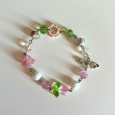 -I wish you roses bracelet inspired by the one and only kali uchis💐🫧 -Bracelet is handmade by me -Bracelet is made out of stainless steel and glass beads -Bracelet length is 7 inches but can be made shorter or longer just message me🎀 -Tags: Kali uchis, cottage core, fairy core, y2k, bracelet, aesthetic bracelet, pretty jewelry, dainty jewelry, flower bracelet, butterfly bracelet, pink, green, pink and green bracelet Fairy Core Beaded Jewelry, Kali Uchis Bracelet, Fairy Core Bracelets, Adjustable Fairycore Bracelets As Gifts, Butterfly Jewelry Aesthetic, Dainty Coquette, Coquette Fairy, Aesthetic Bracelet, Lily Bracelet