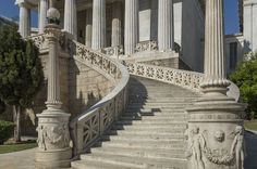 an old building with columns and steps leading up to it