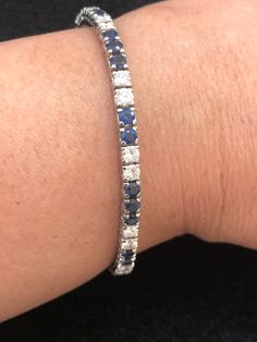 Set your eyes on this gorgeous and elegant vintage platinum cornflower blue sapphire and diamond tennis bracelet. The cornflower blue sapphires weigh approximately 5 carats. The diamonds weigh approximately 3 carats. The diamonds are VS-SI clarity and G-H color. This piece, circa 1950s, weighs 12.11 grams and is 7 inches long. Blue Brilliant Cut Diamond Bracelet For Formal Occasions, Blue Diamond Bracelet With Brilliant Cut Luxury Style, Luxury Blue Diamond Bracelet With Brilliant Cut, Platinum Jewelry With Blue Single Cut Diamonds, Blue Single Cut Diamond Jewelry In Platinum, Blue Platinum Jewelry With Single Cut Diamonds, Classic Sapphire Diamond Bracelet With Brilliant Cut, Blue Brilliant Cut Diamond Bracelet For Wedding, Blue Tennis Bracelet With Prong Setting For Formal Occasions