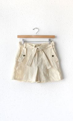 Embroidered, tailored shorts in a beige shade. Features a tie belt and front pockets with faux flap closures. Breathable material made perfect for the summer and spring weather. Pairs well with tank tops or loose blouses. Trouser pants Embroidered Tie belt Front welt pockets Back pockets Zipper closure Inseam: 3 1/2" Front rise: 11 3/8" Waist: 13 3/8" Hips: 22" Self: 100% Rayon Hand wash cold. Dry flat. Low iron, or dry clean Model is wearing a size small Style #: G222P6226 Embroidered Tie, Luxury Women Fashion, Tailored Shorts, Twill Shorts, Spring Weather, Feminine Design, Loose Blouse, Linen Shorts, Trouser Pants