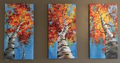 three paintings of trees painted on canvases