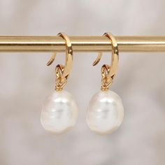 A stunning pair of gold drop earrings with a stunning white freshwater pearl Guaranteed to add a touch of luxury to any look, our ivory pearl earrings are crafted from the finest sterling silver and plated with warming yellow gold. As always, only the pearls with the finest lustre handpicked from our selection. These dainty gold drop earrings feature a classic hook fastening and are suitable for almost any age. A lovely Christmas gift, stocking filler or for a birthday treat for anyone born in J White Hoop Earrings With Baroque Pearl Charm, White Baroque Pearl Hoop Earrings With Charm, Elegant Gold Plated Hoop Earrings With Pearl Pendant, Classic Gold-plated Pearl Drop Bridal Earrings, Classic Gold Plated Pearl Drop Bridal Earrings, White Gold-plated Dangle Pearl Earrings, White Gold Plated Dangle Pearl Earrings, Classic White Gold-plated Pearl Earrings, Yellow Gold Teardrop Earrings With Pearl Chain