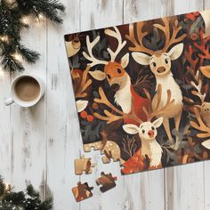 a wooden table topped with puzzle pieces and a cup of coffee