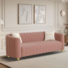 a living room with pink velvet couches and white rugs