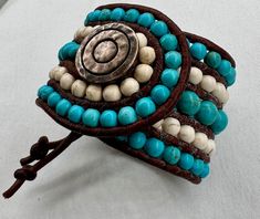 Beaded Cuff Bracelet in Turquoise & White, 3mm Leather Cord and Metal Button Closure. Cowgirl Boho Gift for Her, Handmade Statement Bracelet - Etsy Handmade Turquoise Leather Bracelet Spiritual, Handmade Turquoise Wrap Bracelet, Handmade Turquoise Leather Bracelet, Bohemian Style, Bohemian Turquoise Leather Bracelet With Round Beads, Handmade Turquoise Leather Bracelet In Bohemian Style, Handmade Bohemian Turquoise Leather Bracelet, Handmade Adjustable Turquoise Leather Bracelet, Handmade Southwestern Turquoise Leather Bracelet, Handmade Adjustable White Leather Bracelet