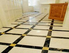 a black and white checkered floor in a room with wooden cabinets on either side