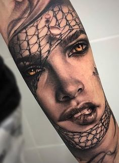 a woman's face is covered in black and white lace on her arm, with an orange eye