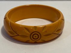 a yellow bracelet sitting on top of a white table