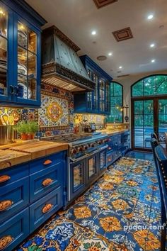 a kitchen with blue cabinets and tile flooring in the middle of it is shown