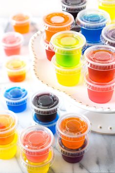 there are many different colored jello shots in the tray on the table with text overlay