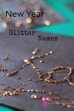 the name glitter names written in gold and silver beads on top of a piece of fabric