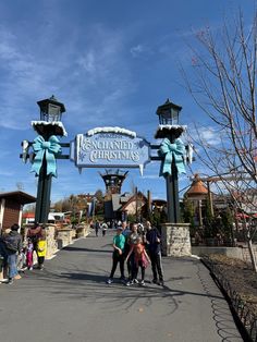 some people are standing in front of the entrance to disneyland's christmas time attraction