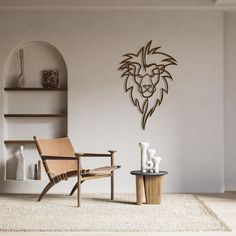 a living room with a chair, table and lion head wall decal on the wall