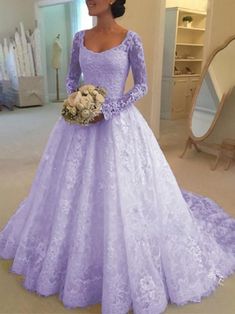 a woman in a purple wedding dress standing next to a mirror