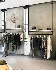 a clothing store with clothes hanging on racks