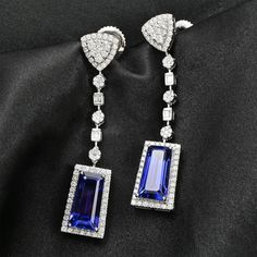 Styled with clean lines and symmetry, these limited-edition tanzanite earrings in 950 platinum resonate with iconic jewelry brands. Showcasing rare tanzanite gems of a unique taper baguette shape, these earrings are studded with top-quality diamonds for a sparkling contrast. These collectible earrings have an unmatched value for high-end jewelry connoisseurs. Luxury Tanzanite Earrings, Luxury Tanzanite Jewelry For Evening, Luxury Blue Baguette Cut Earrings, Luxury Tanzanite Drop Earrings, Formal Tanzanite Baguette Cut Jewelry, Elegant Tanzanite Formal Earrings, Elegant Tanzanite Dangle Earrings, Elegant Tanzanite Earrings For Formal Occasions, Luxury Tanzanite White Gold Earrings