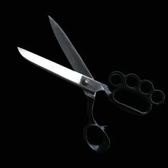 a pair of scissors on a black background with one cut open and the other closed