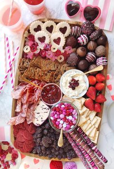 valentine's day dessert platter with chocolates, strawberries, pretzels and more