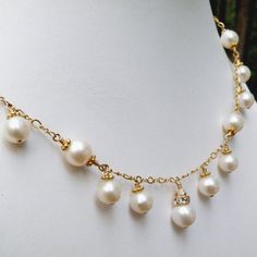 This romantic white pearl necklace is handmade with perfectly polished natural freshwater pearls and just enough sparkly Swarovski crystal accents. Expertly hand wire wrapped with 14k gold filled wire, chain and clasp. A gorgeous statement necklace for a blushing bride on her wedding day. A thoughtful gift for a woman born in June since her birthstone is the precious pearl.Necklace Details:- Necklace Length is 18 inches (43.18 cm) plus a 1 inch extender for the perfect fit- The central pendant l Exquisite Pearl Necklace For Anniversary, Gold Wire Wrapped Pearl Necklace For Wedding, Beaded Pearl Necklace For Anniversary, Beaded Akoya Pearl Wedding Jewelry, Elegant Pearl Jewelry With Wire Wrapped Detail, Pearl Wire Wrapped Necklace For Wedding, Wire Wrapped Pearl Necklace For Wedding, Akoya Pearl Bridal Necklace With Pearl Charm, Wedding Pearl Necklace With Wire Wrap