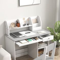 a white desk and chair in a room with a potted plant on the floor