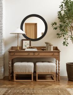 a room with a table, mirror and stools