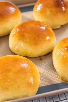 baked bread rolls sitting on top of a baking sheet